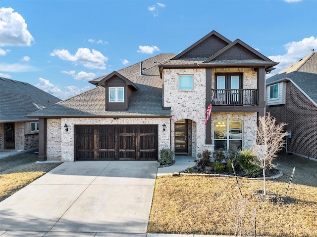 view of front of home with a balcony and a garage