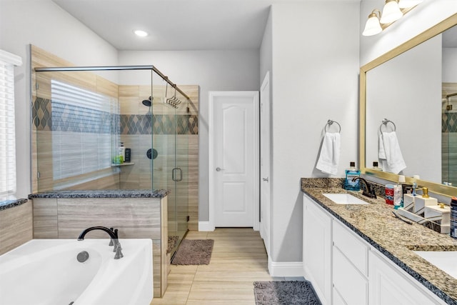 bathroom featuring plus walk in shower, tile patterned floors, and vanity