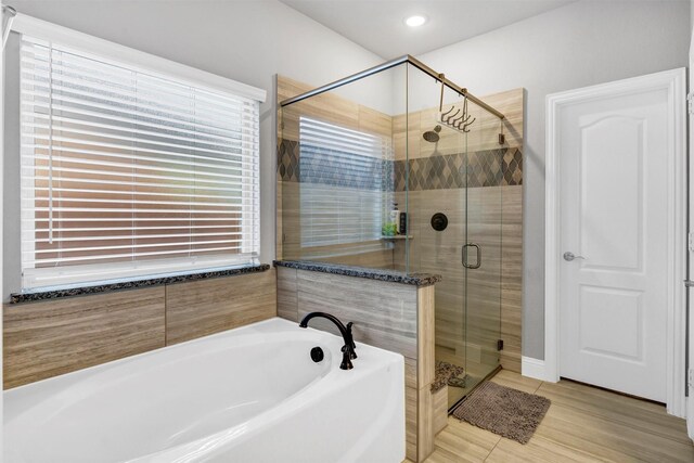 bathroom with tile patterned flooring and independent shower and bath