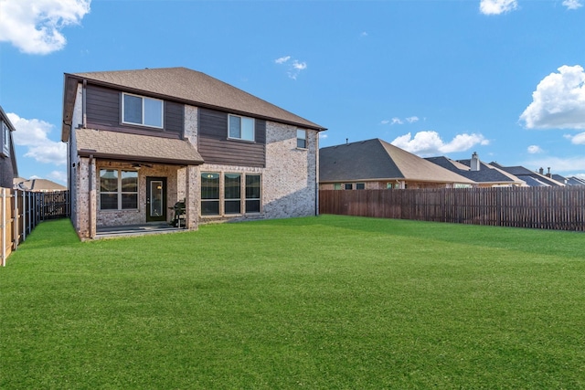 rear view of property featuring a lawn