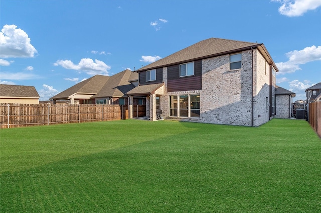 rear view of house with a yard