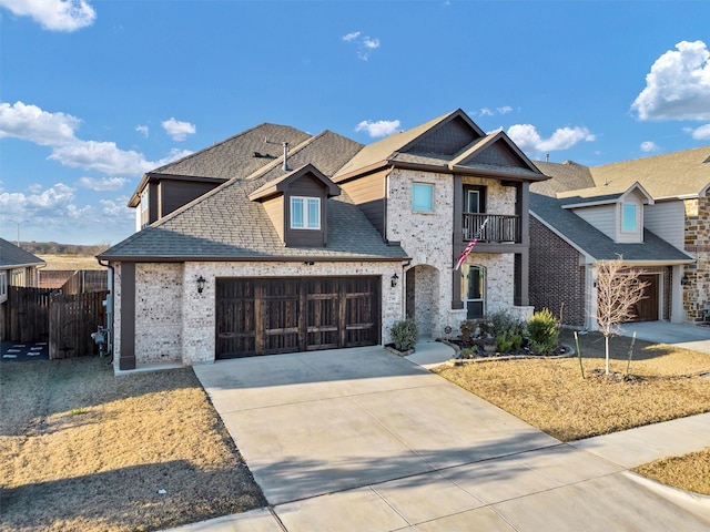 view of front of property featuring a balcony and a garage