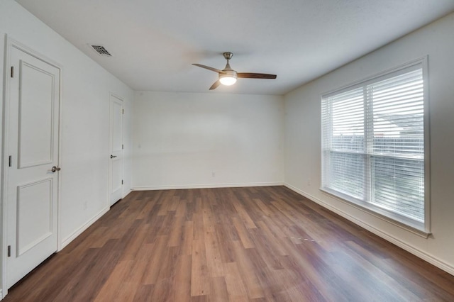 spare room featuring ceiling fan and dark hardwood / wood-style floors