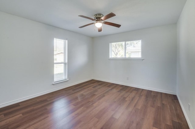 spare room with ceiling fan and dark hardwood / wood-style floors