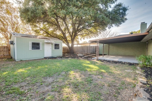 view of yard with a storage unit and a patio