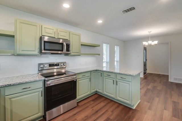 kitchen featuring stainless steel appliances, kitchen peninsula, green cabinetry, light stone counters, and an inviting chandelier