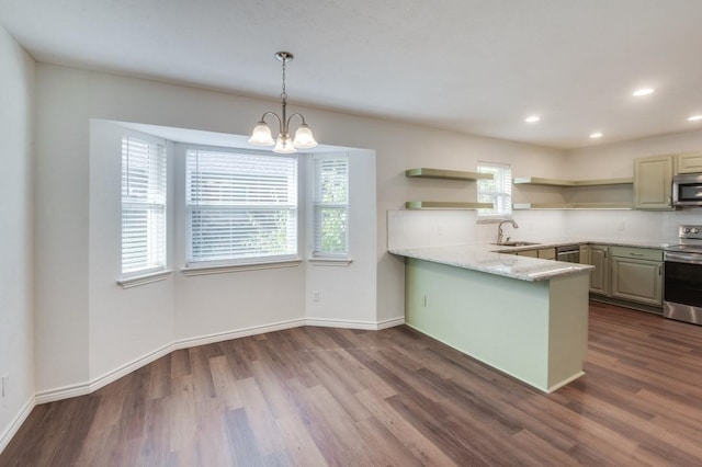 kitchen with stainless steel appliances, decorative light fixtures, a healthy amount of sunlight, and kitchen peninsula