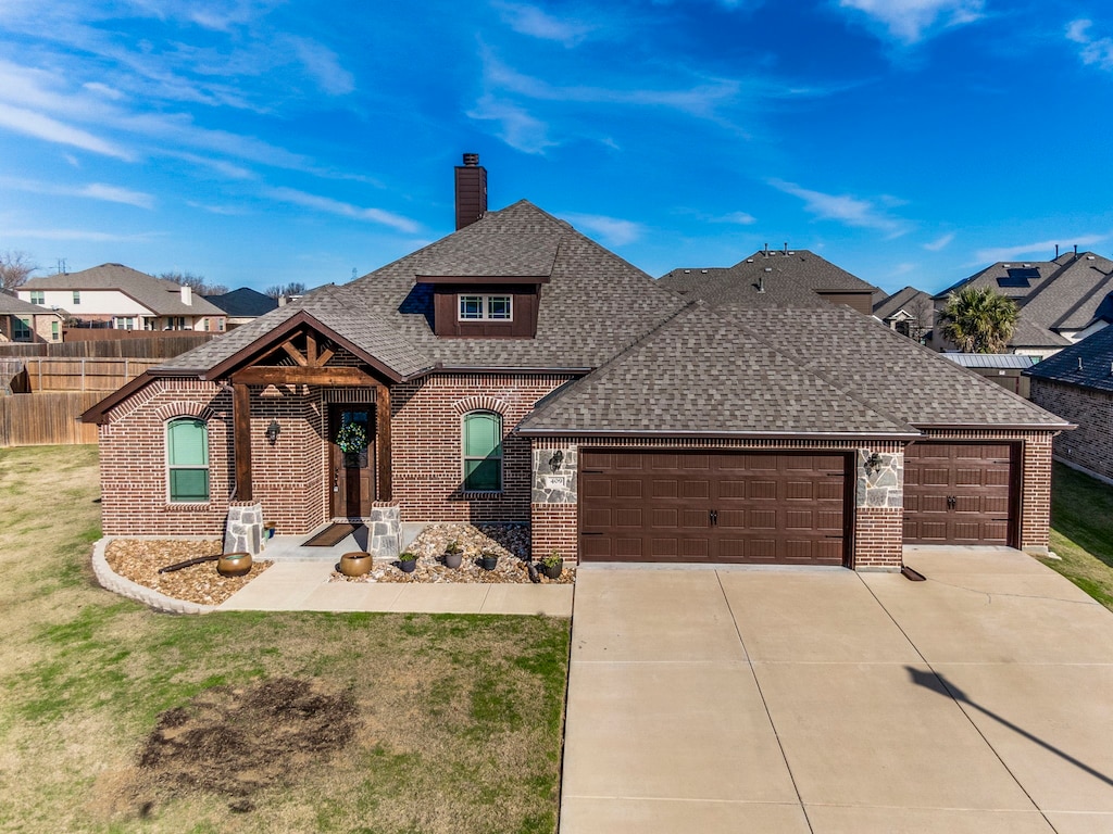 view of front of house with a front yard and a garage