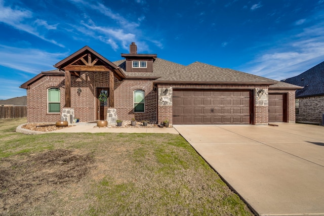 view of front of house with a front yard and a garage