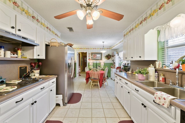 kitchen featuring white cabinetry and a textured ceiling