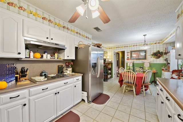 kitchen with decorative light fixtures, a textured ceiling, white cabinets, light tile patterned floors, and stainless steel fridge with ice dispenser