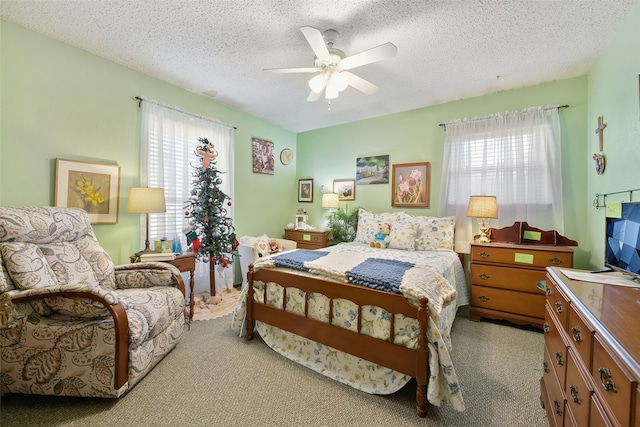 bedroom with ceiling fan, multiple windows, and a textured ceiling