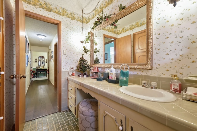 bathroom with vanity and a textured ceiling