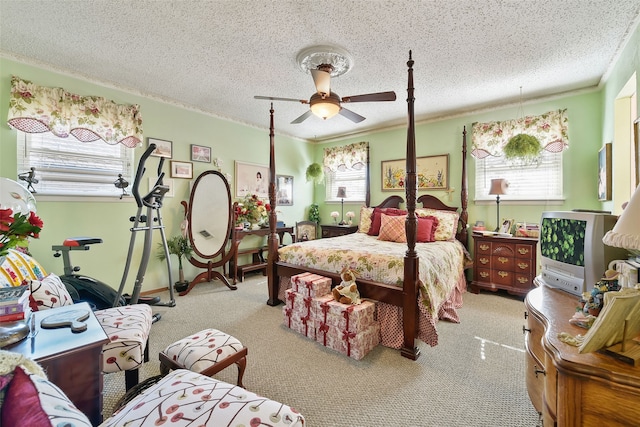 carpeted bedroom featuring a textured ceiling, ceiling fan, and crown molding