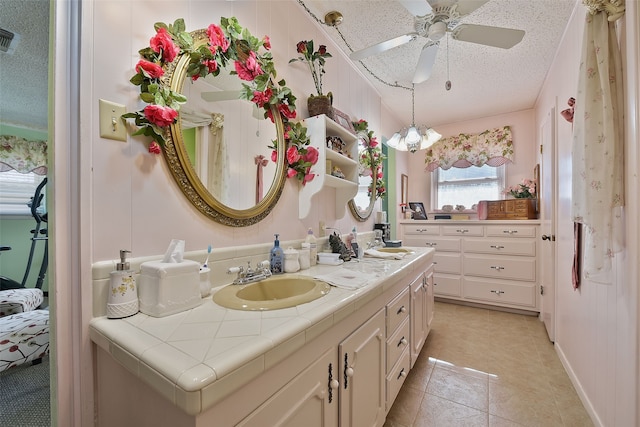 bathroom featuring tile patterned flooring, a textured ceiling, ceiling fan, and vanity