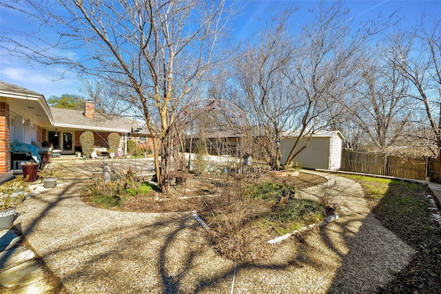 view of yard featuring an outbuilding and a garage