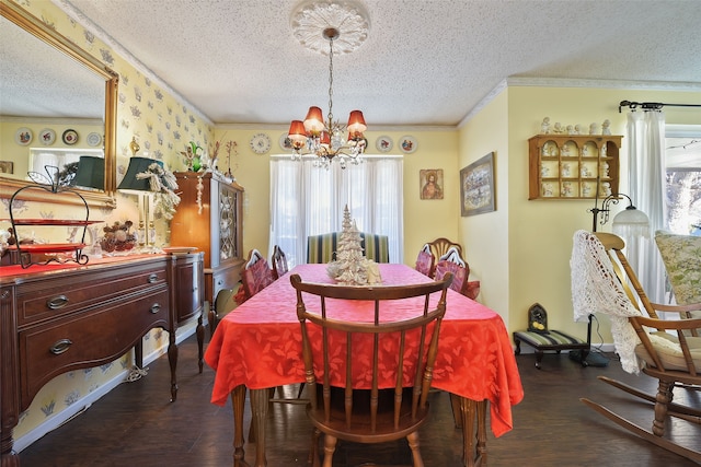 dining space with a textured ceiling, dark wood-type flooring, ornamental molding, and a chandelier