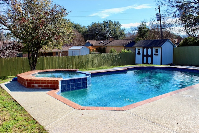 view of pool with an outbuilding, a pool with connected hot tub, a fenced backyard, and a shed