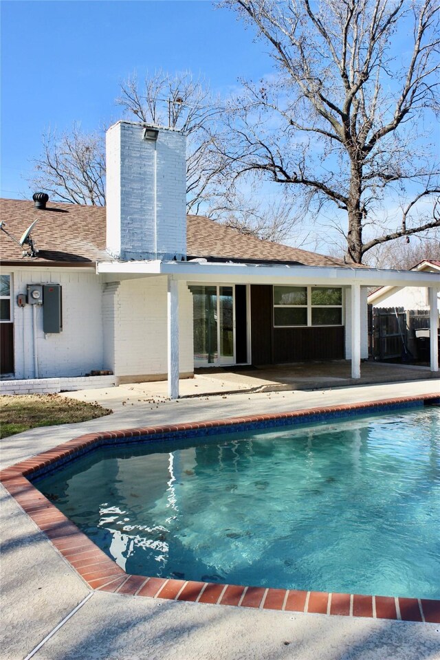 outdoor pool with a patio area