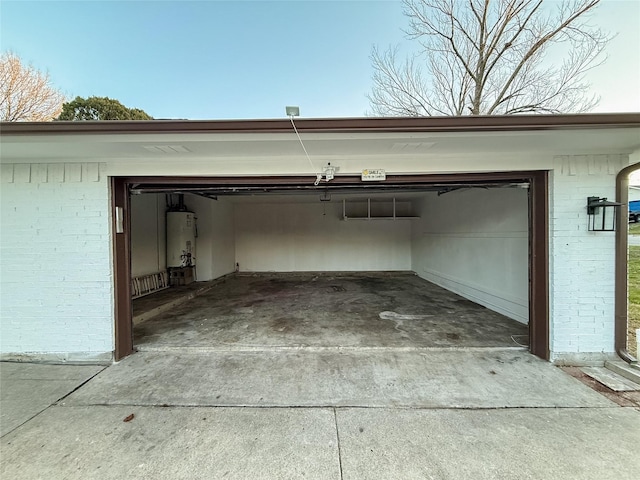 garage with water heater and driveway