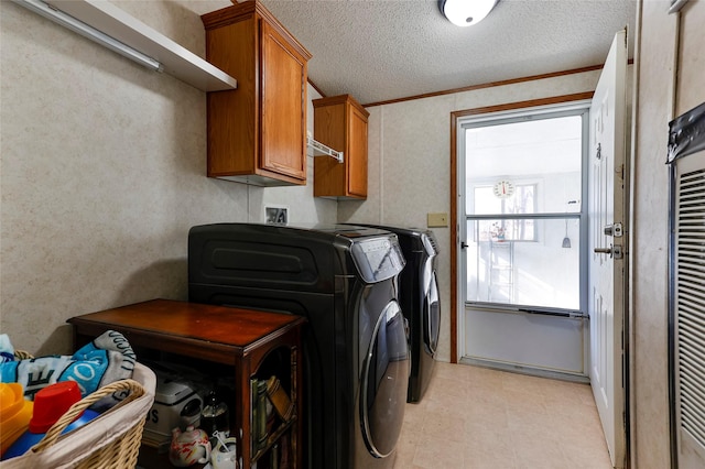 washroom featuring washer and dryer, cabinets, crown molding, and a textured ceiling