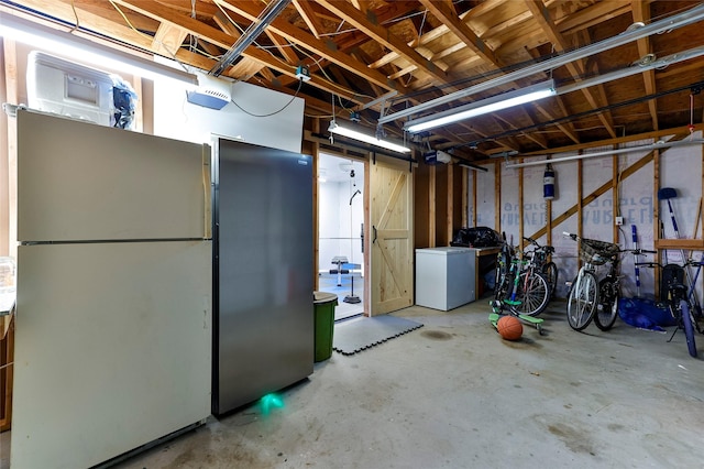 basement with white refrigerator, fridge, and stainless steel refrigerator