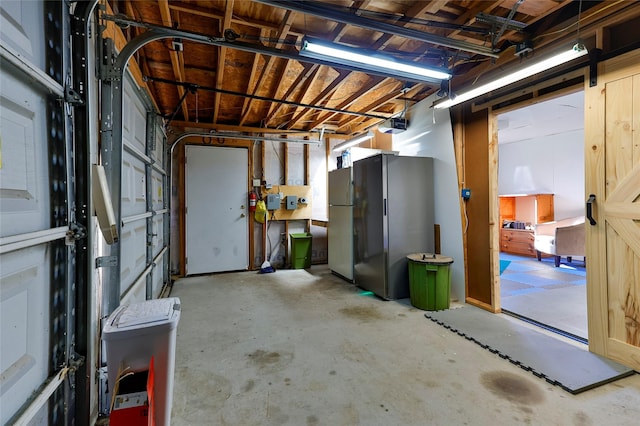 basement featuring fridge and stainless steel refrigerator