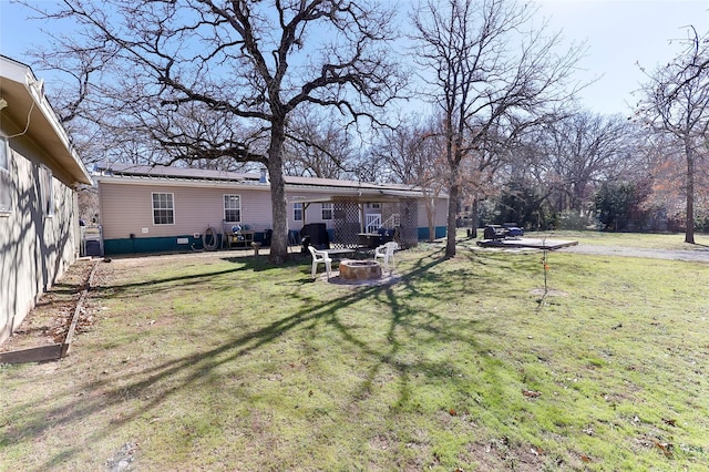 view of yard with an outdoor fire pit and a patio area