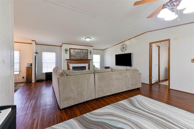 living room with ornamental molding, ceiling fan, vaulted ceiling, and dark hardwood / wood-style floors