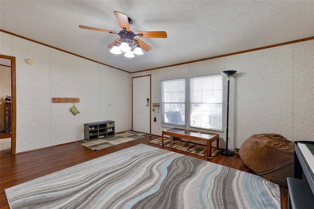 living area with a textured ceiling, ceiling fan, crown molding, and wood-type flooring