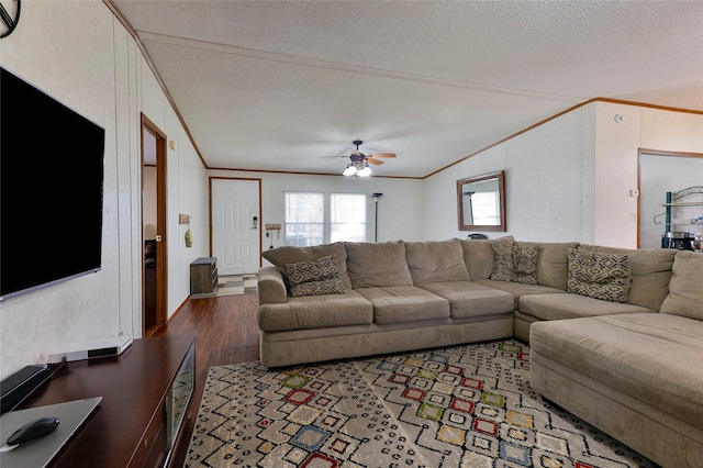 living room featuring ornamental molding, dark wood-type flooring, a textured ceiling, and ceiling fan