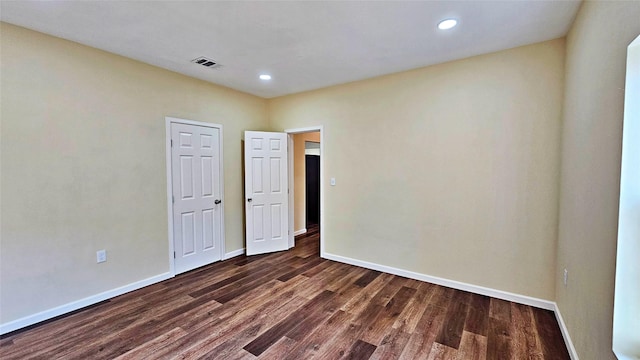 unfurnished room featuring dark hardwood / wood-style flooring