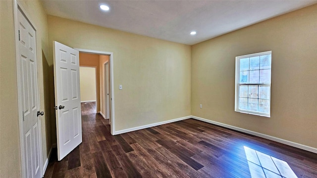 empty room with dark hardwood / wood-style floors