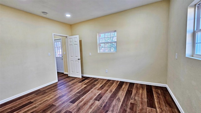 empty room with dark wood-type flooring