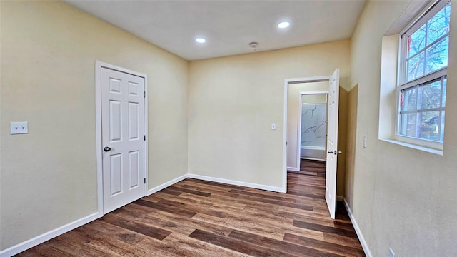 unfurnished room with dark wood-type flooring