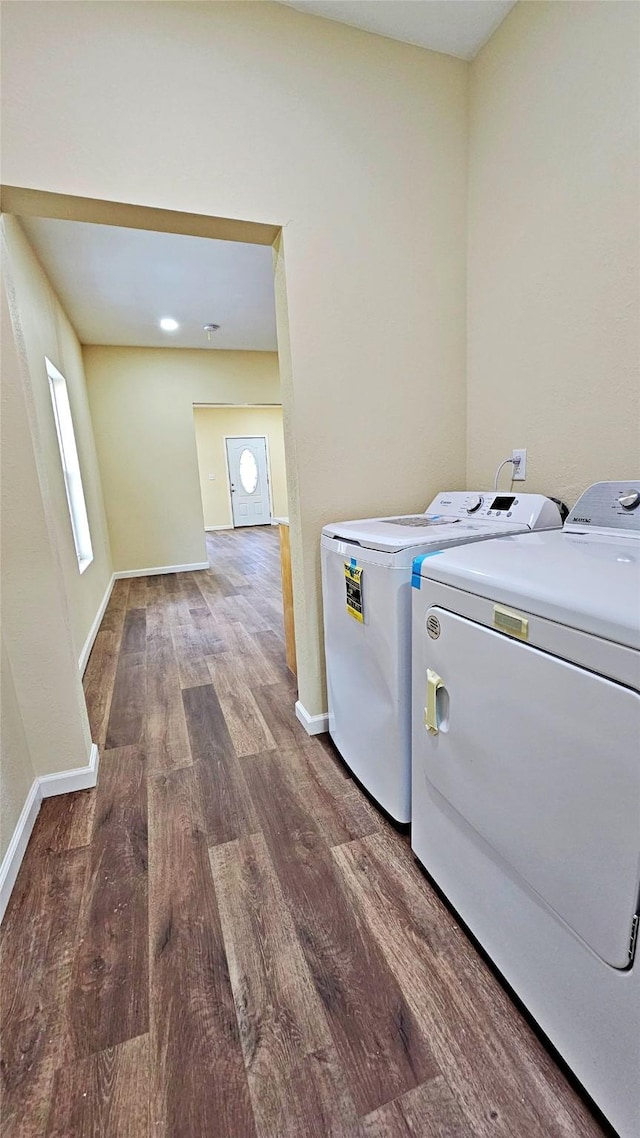 washroom featuring hardwood / wood-style floors and washing machine and clothes dryer