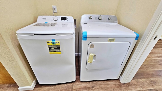 washroom featuring independent washer and dryer and hardwood / wood-style flooring