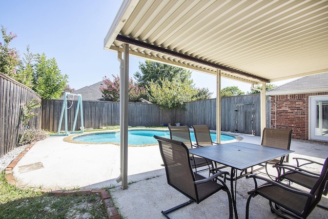 view of patio / terrace with a fenced in pool