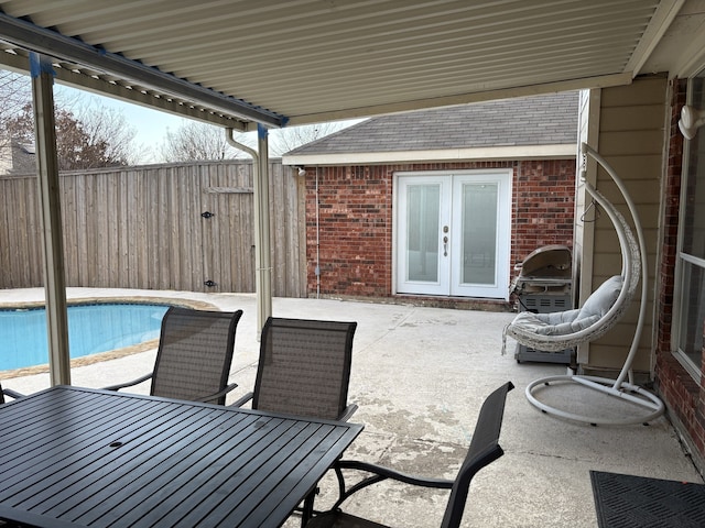 view of patio with a fenced in pool and french doors