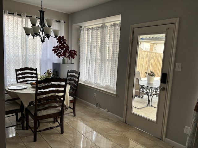 dining space featuring light tile patterned floors and a chandelier