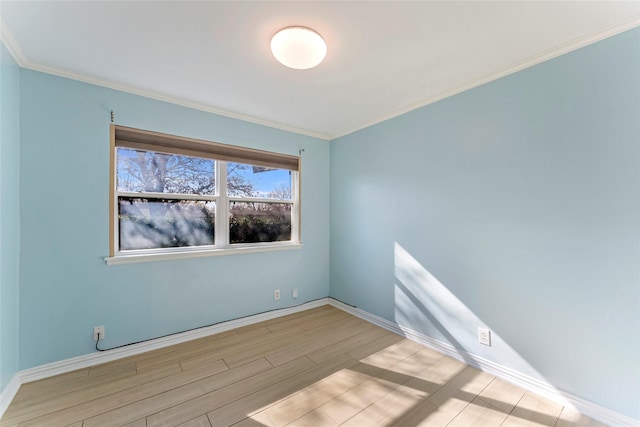 spare room with light wood-type flooring and ornamental molding