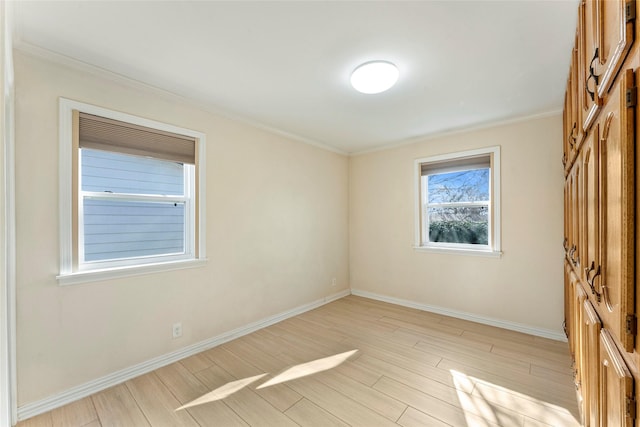 unfurnished room featuring crown molding