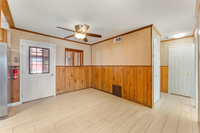 spare room featuring ceiling fan and crown molding