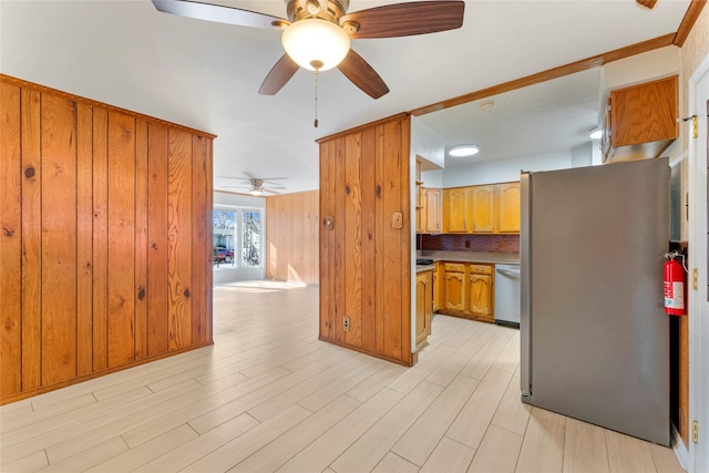 kitchen featuring backsplash, light wood-type flooring, ceiling fan, and stainless steel appliances