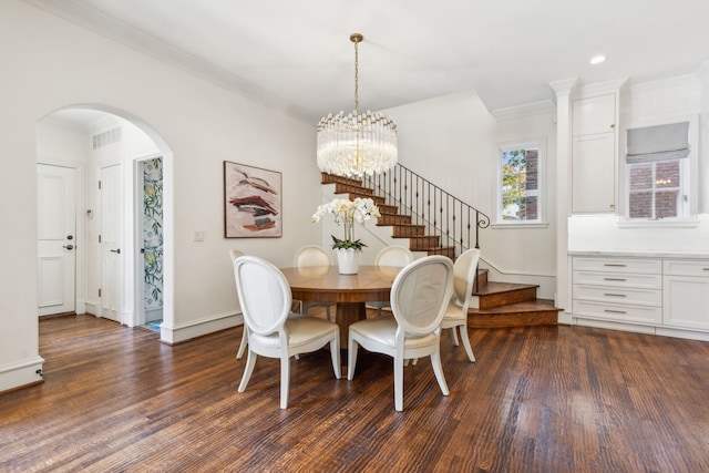 dining room featuring a notable chandelier, crown molding, and dark hardwood / wood-style flooring