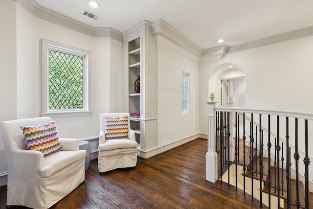 living area featuring crown molding and dark hardwood / wood-style flooring