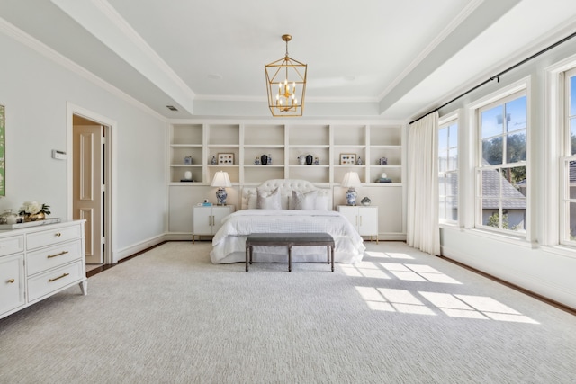 carpeted bedroom with an inviting chandelier, ornamental molding, and a tray ceiling