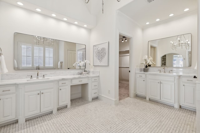 bathroom featuring an inviting chandelier, tile patterned flooring, ornamental molding, and vanity