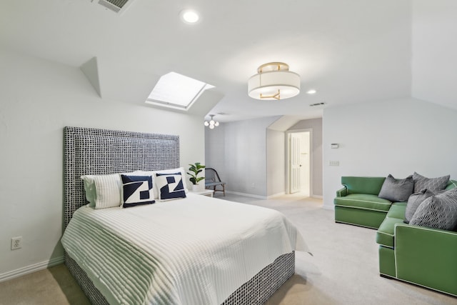 carpeted bedroom with vaulted ceiling with skylight