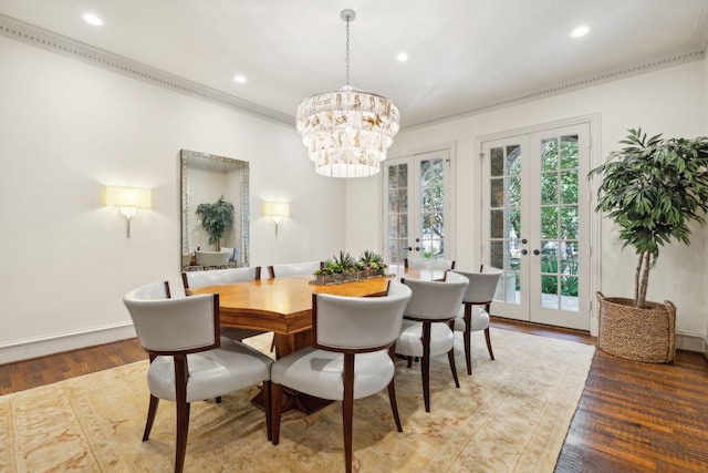 dining area with ornamental molding, french doors, an inviting chandelier, and wood-type flooring